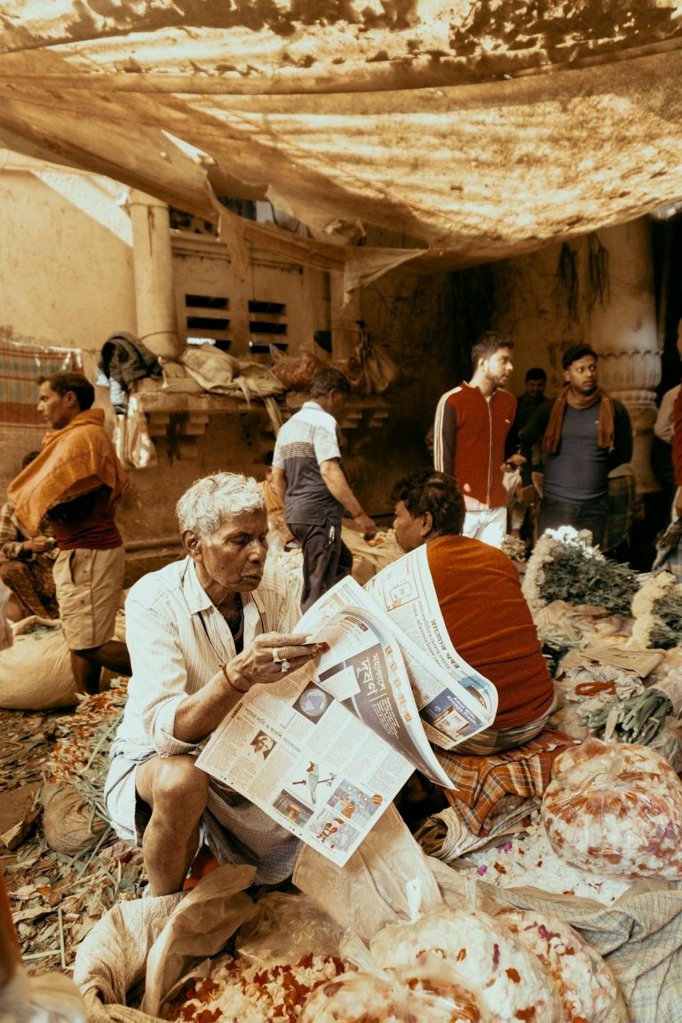 A lively market with diverse individuals engaging in shopping and reading.