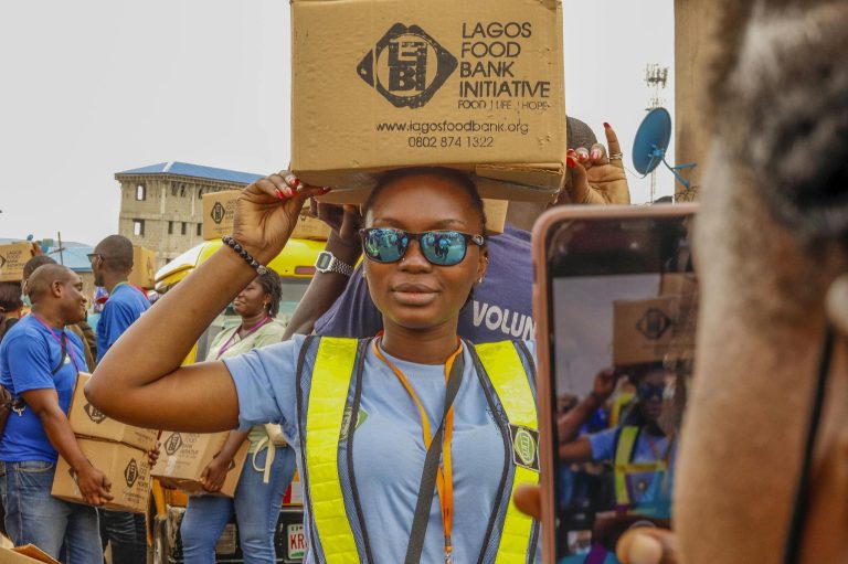 Volunteers distribute food boxes at the Lagos Food Bank Initiative, supporting local communities.